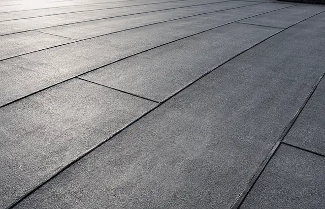 Flat roofing surface with black membrane and seams
