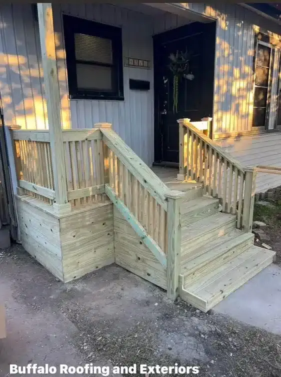 Newly constructed wooden deck and stairs by Buffalo Roofing and Exteriors.