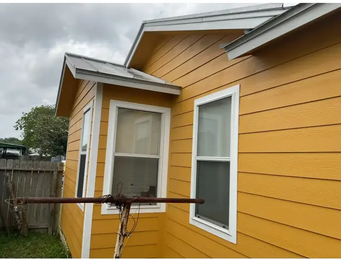 Yellow house exterior and roofing project in Texas