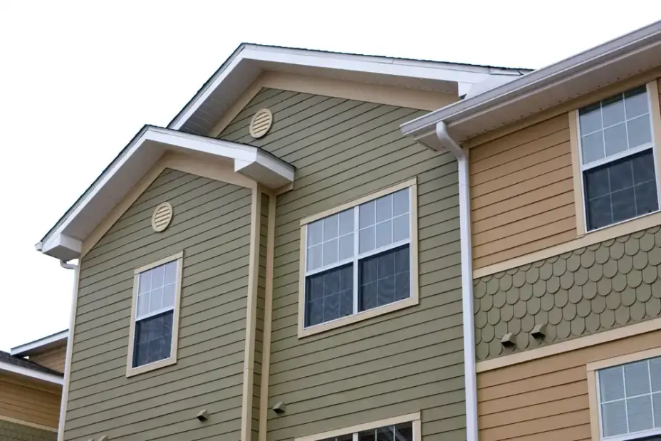Fresh siding installation on a commercial building exterior and roof.