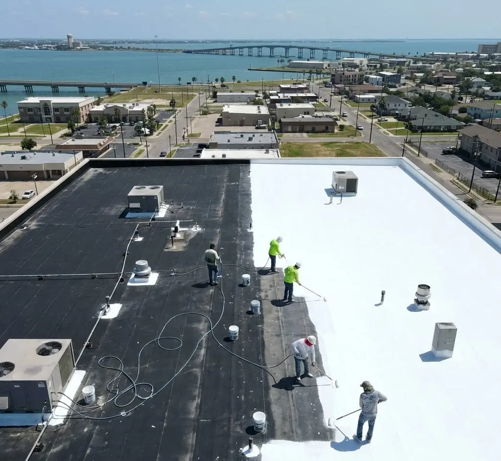 Crew coating a commercial flat roof in Corpus Christi