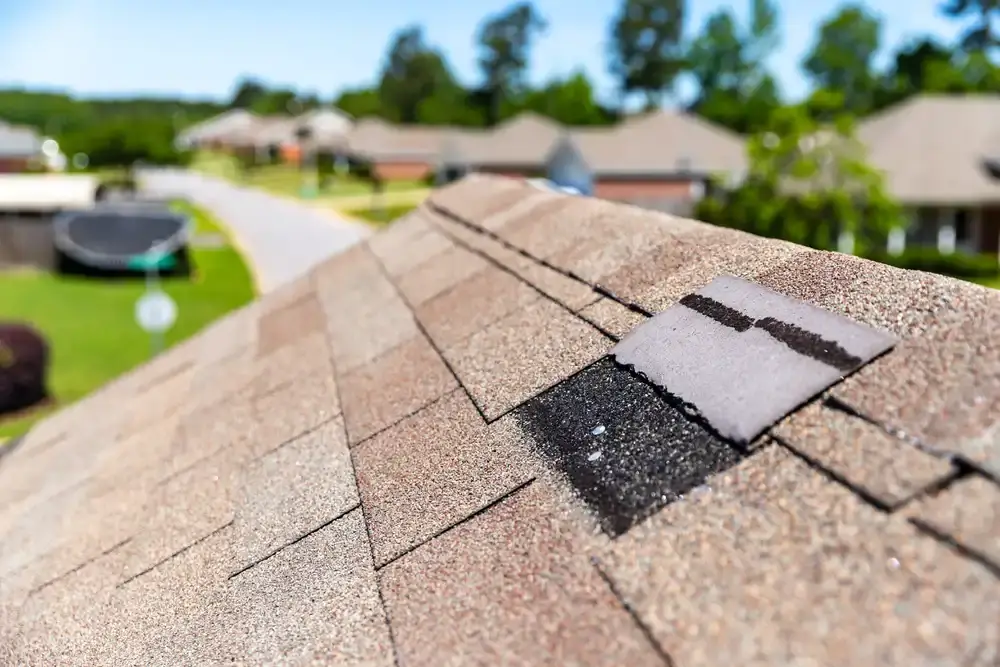Missing shingle on a roof highlighting potential water damage risks and the importance of timely roofing repairs for home protection.