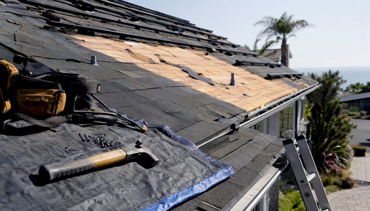 Roof replacement site with solar panel mounts