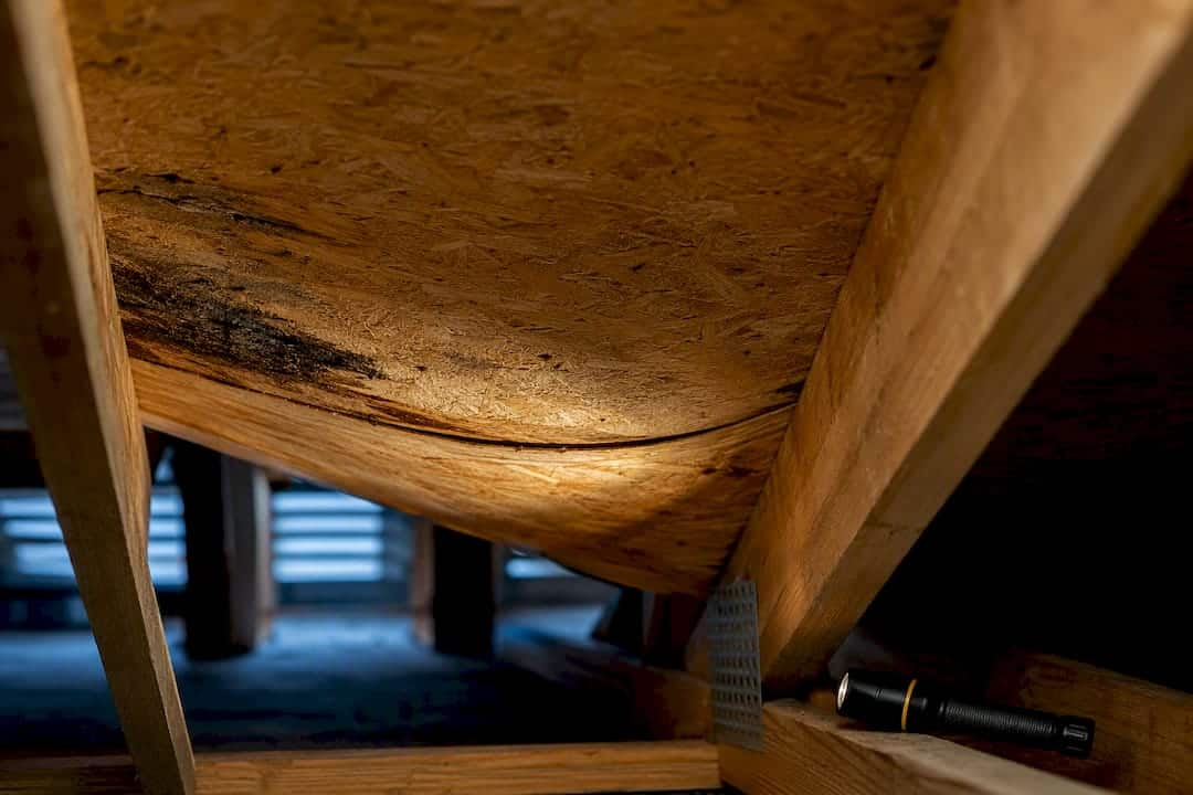 Sagging roof sheathing between attic rafters